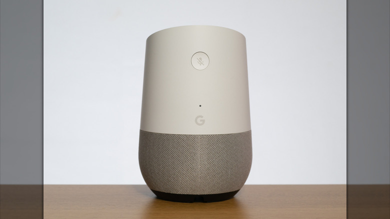 An old Google Home speaker on a table.