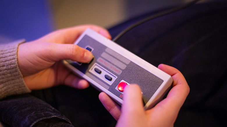 A person holding the NES controller in their hands
