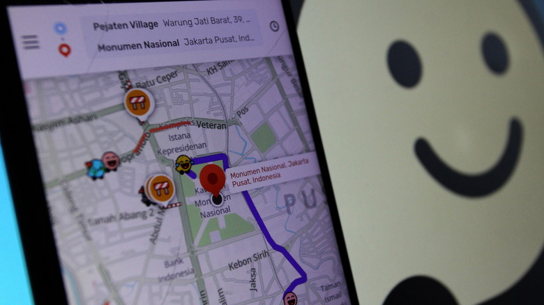 Waze app on phone screen showing warnings for detours on map