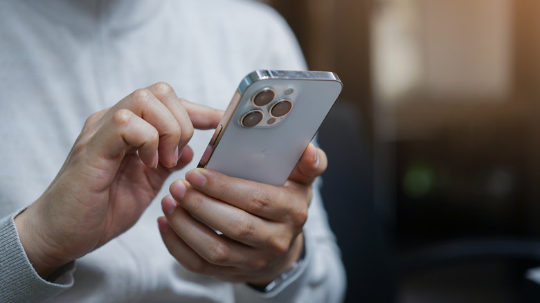 Close-up of a person holding an iPhone