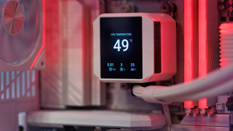 A digital cooler placed inside a computer case, showing the current temperature