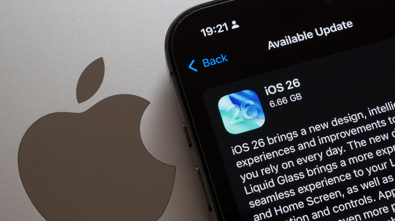 iPhone showing the iOS 26 update placed on a MacBook