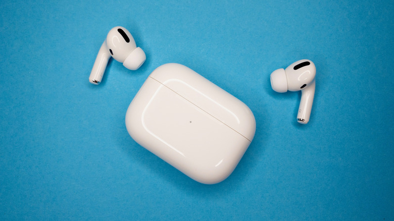 Apple AirPods pro outside the case against a blue background