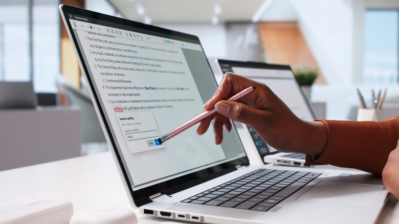 A person proofreading a digital document.
