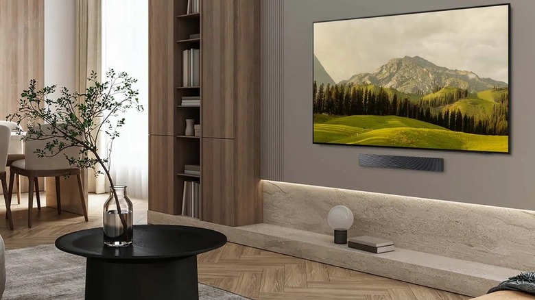 OLED S85F 4K Samsung smart TV mounted to wall in den