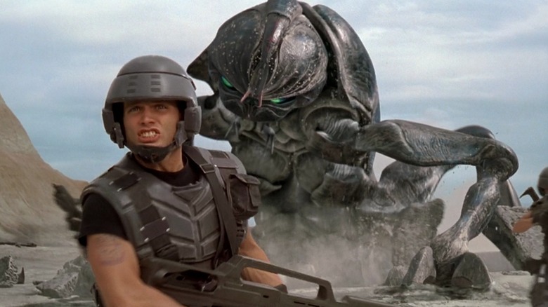 Mobile infantry trooper surprised by giant bug in Starship Troopers