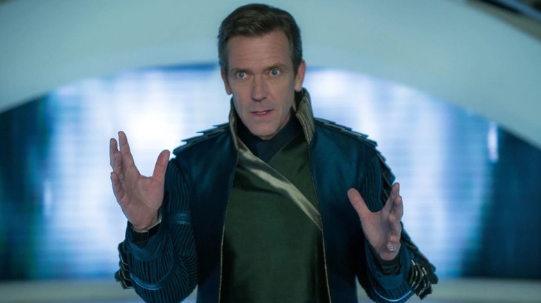 Hughl Laurie as David Nix holding up his hands in Tomorrowland