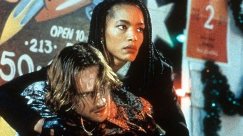 Angela Bassett holding Ralph Fiennes in Strange Days