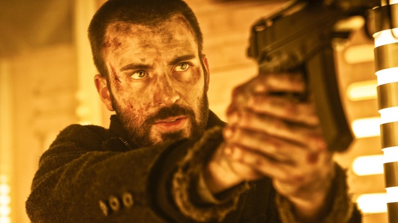 Curtis (Chris Evans) aiming a gun in Snowpiercer