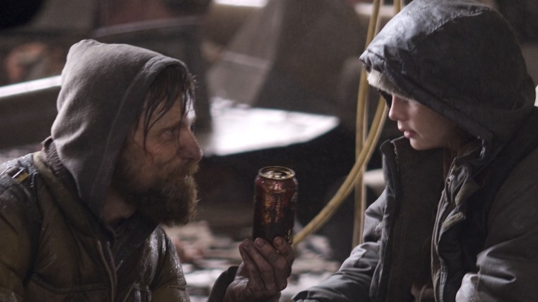 Man (Viggo Mortensen) and Boy (Kodi Smit-McPhee) looking at a can in The Road