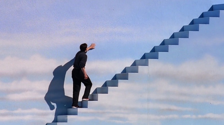 Jim Carrey as Truman Burbank walking up the stairs in The Truman Show