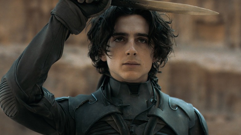 Paul Atreides (Timothee Chalamet) saluting with his knife in Dune (2021)