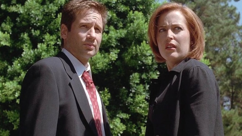 Mulder and Scully standing together, frowning, in "The X-Files"