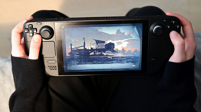 Someone playing a game on their Steam Deck in a cozy setting.