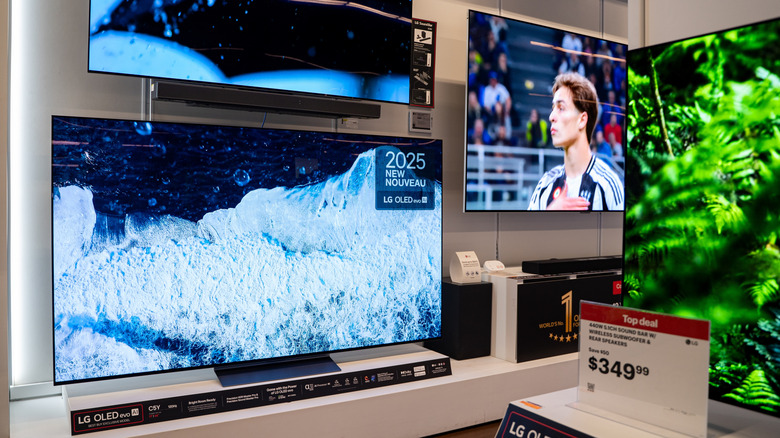 OLED TVs on display in an electronics store.