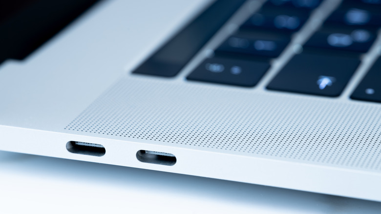 USB-C ports on the edge of a MacBook laptop
