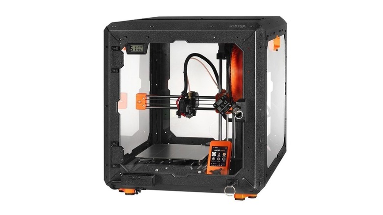 Original Prusa Mini+ 3D printer inside a black enclosure.