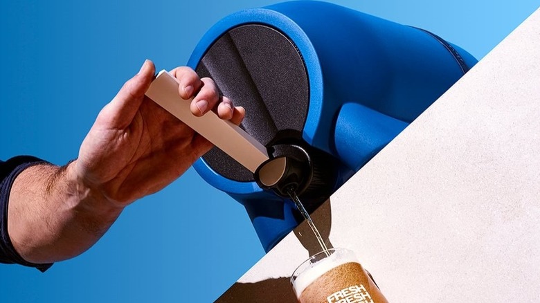 Pinter craft beer brewer, in blue, dispensing beverage from its tap.