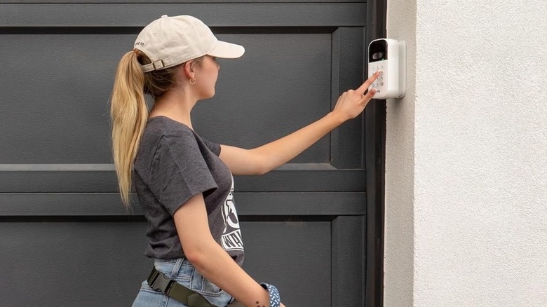 Woman using myQ Smart Garage Door Video Keypad