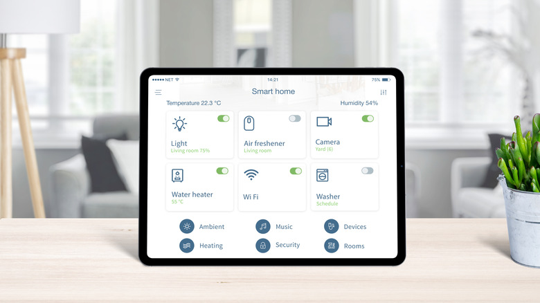 close-up tablet showing smart home controls in living area