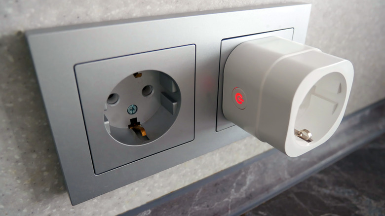 Smart plug inserted into a wall electrical outlet.