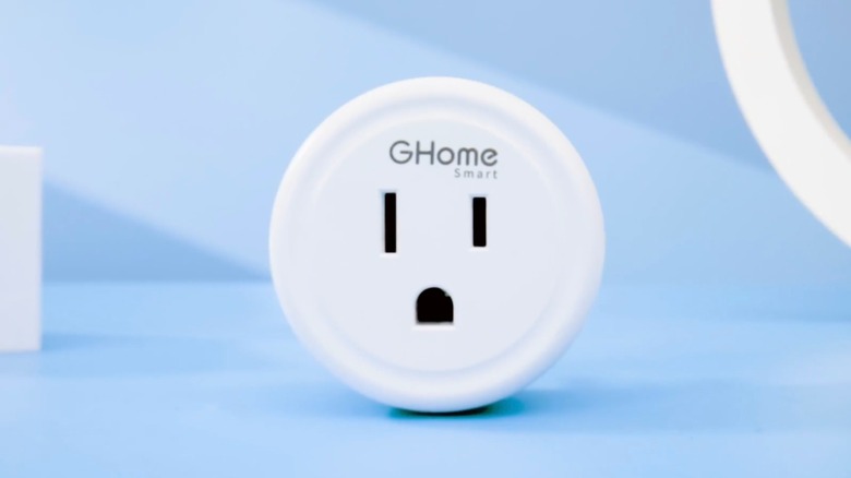 A closeup of the GHome Smart Plug as it sits against a blue backdrop