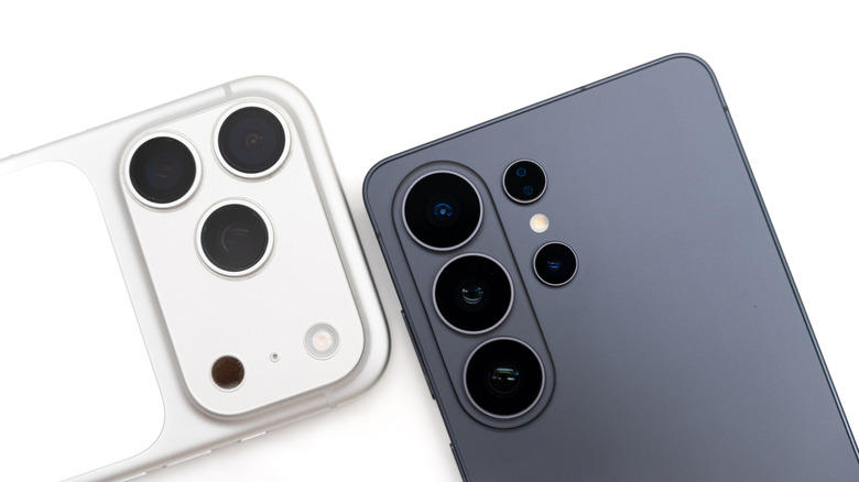 iPhone 17 Pro and Samsung Galaxy S26 Ultra shown side by side with rear camera lenses visible.