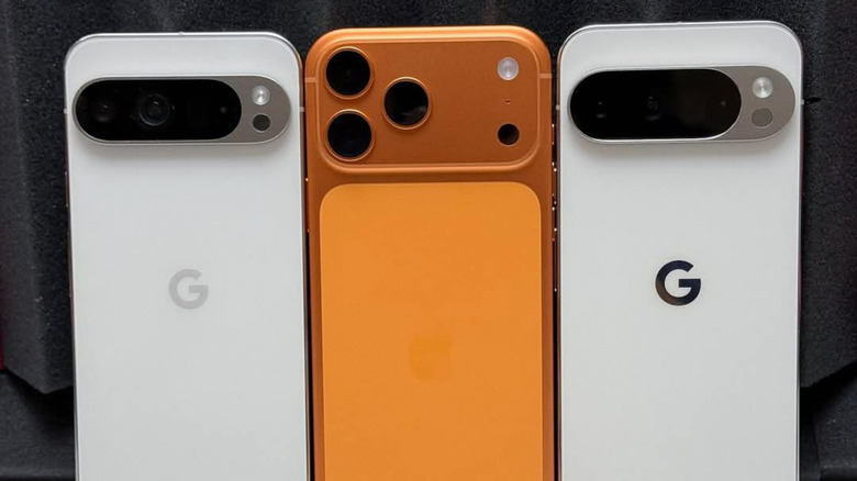 An iPhone 17 Pro Max in between two Pixel phones.