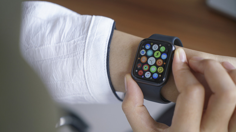 An Apple Watch with numerous apps icons on the screen