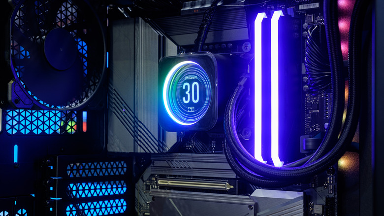 Liquid cooling pump with an RGB display inside a gaming PC.