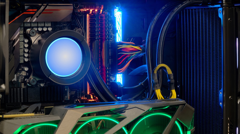 Liquid-cooled gaming PC with RGB lighting and internal components visible.