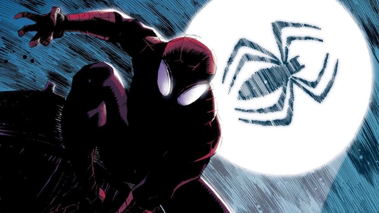 Spider-Man on a wall with the Spider-Signal behind him