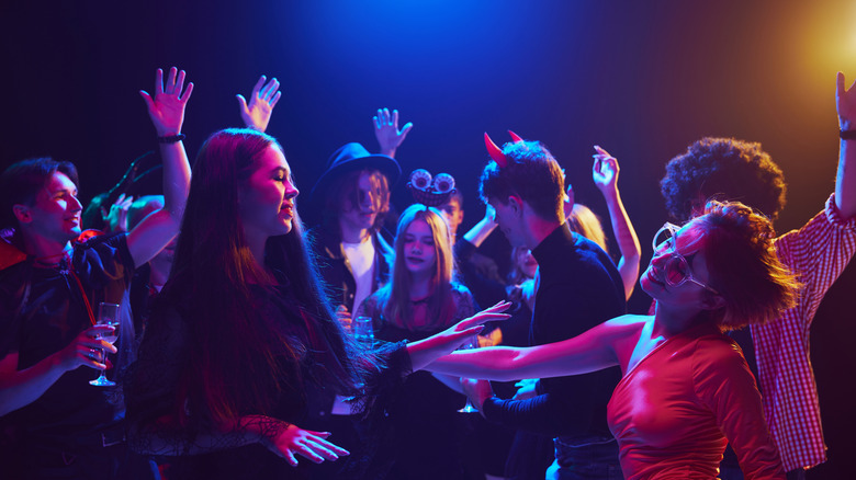 A group of people dancing and listening to music