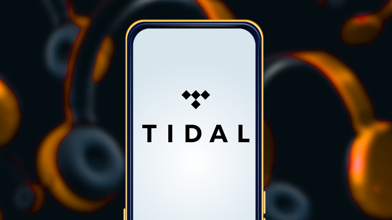 Tidal logo on a smartphone screen with headphones in the background