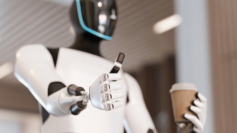 Android in office carrying cup of coffee