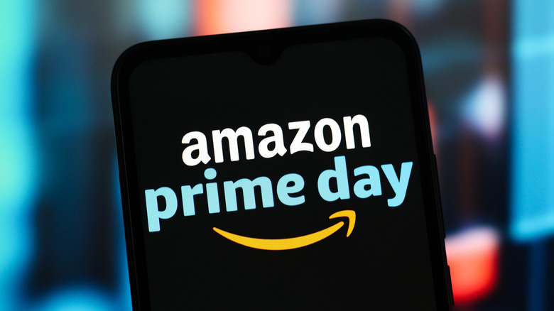 A smartphone displaying the Amazon Prime Day logo as it sits against a blurred background