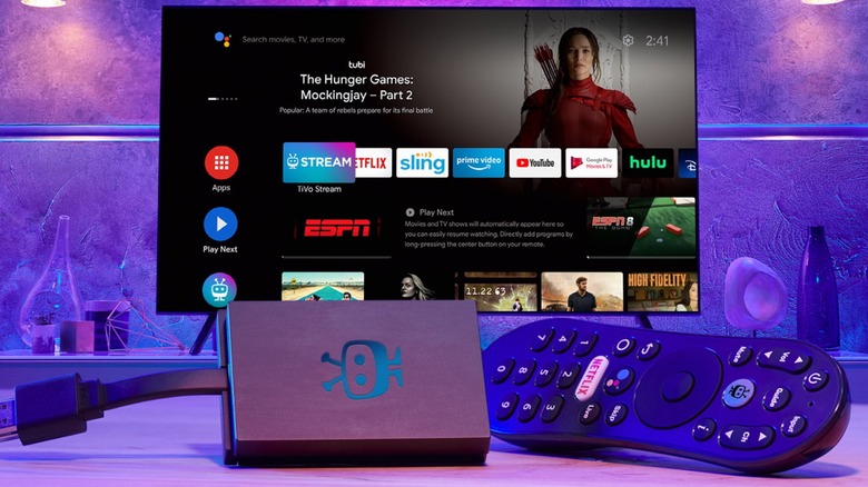 TiVo Stream 4K device and remote with TV in background