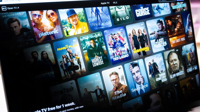 A closeup of a computer screen showing Apple TV show and movie tiles and icons