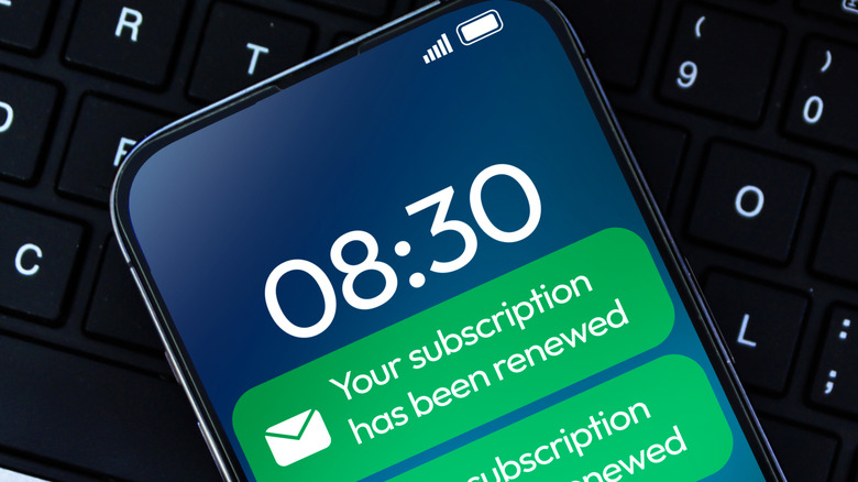 A closeup of a phone showing notifications that talk about subscription renewals