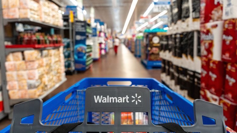 A shopping cart with a Walmart logo in a store