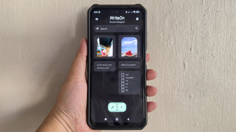 Hand holding Android phone showing WriteOn app