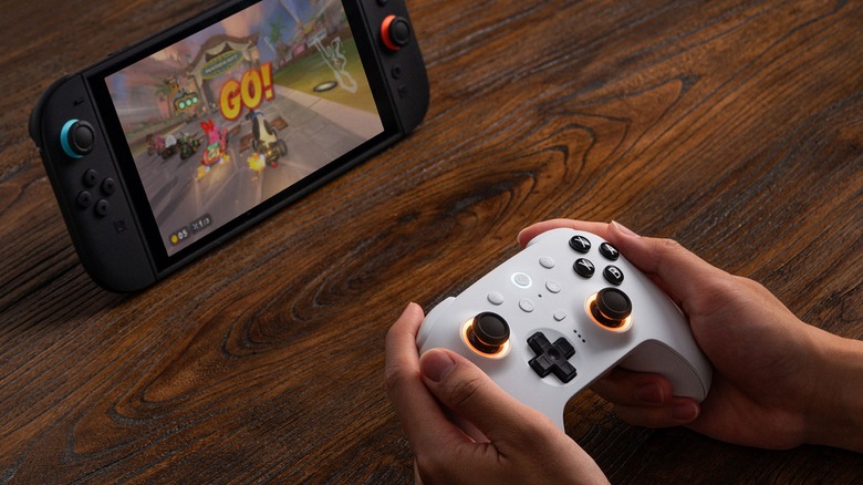 Person Playing Mario Kart World on the Switch 2 with an 8BitDo Ultimate 2 controller