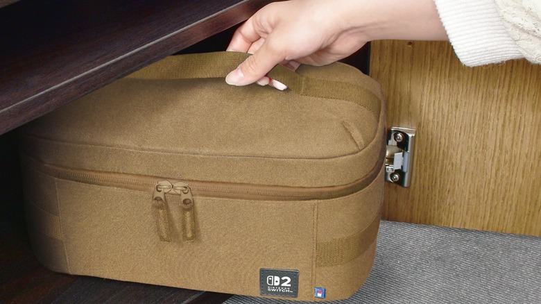Person removing Hori Switch 2 sand colored Compact Cary All Case from cupboard