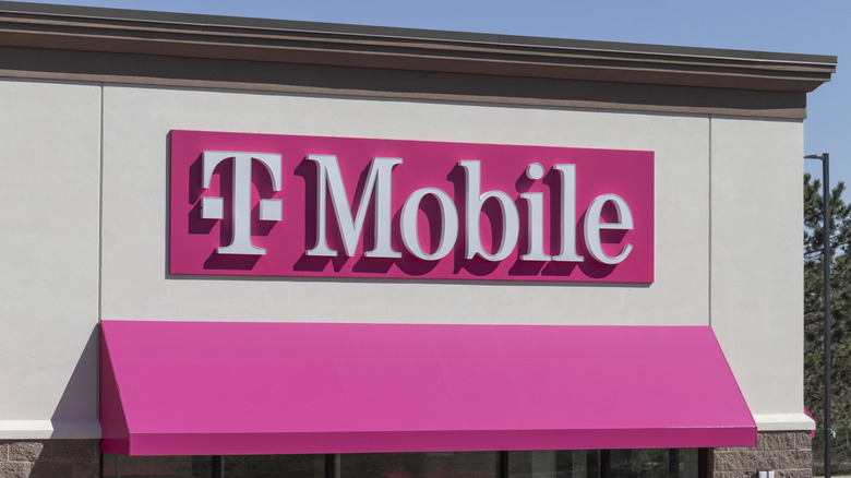 An exterior shot of a T-Mobile store, the company's logo is prominent in the photo