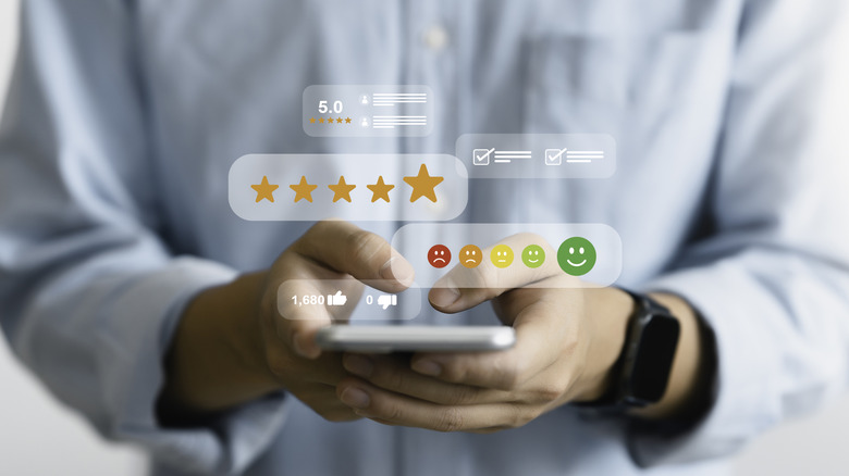 Review icons and ratings with man on smartphone in the background