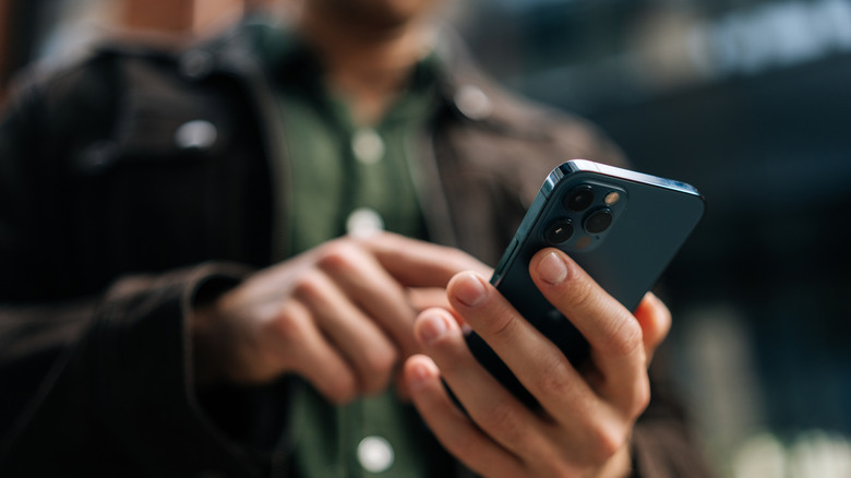 Man using a smartphone to text and browse the internet