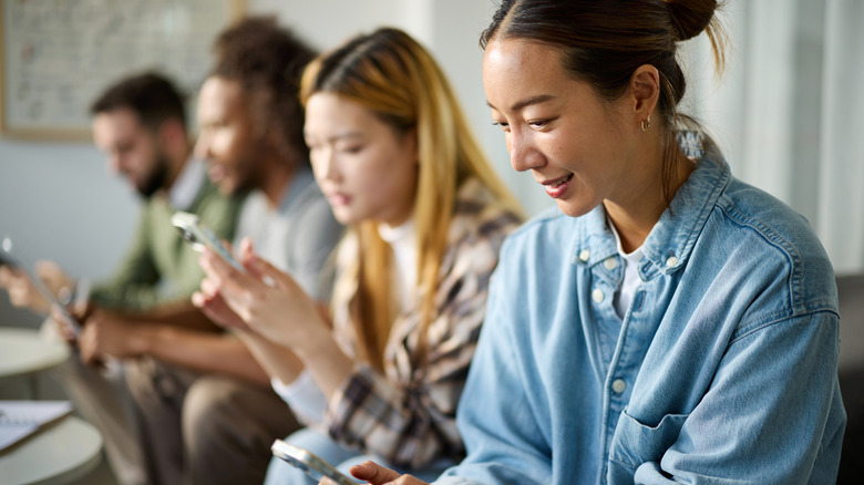 Multiple people together all on their phones
