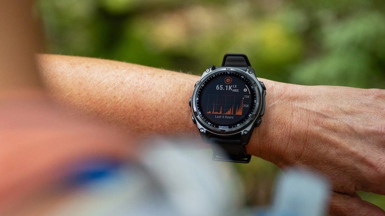 A person looking at their Garmin smartwatch