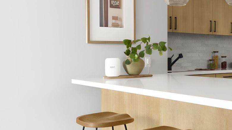 A white Amazon eero wifi access point on a white kitchen island