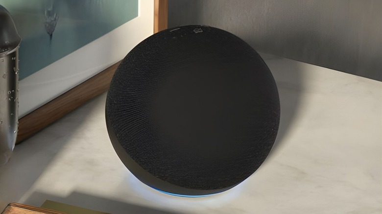 Echo Dot in black on a marble surface.